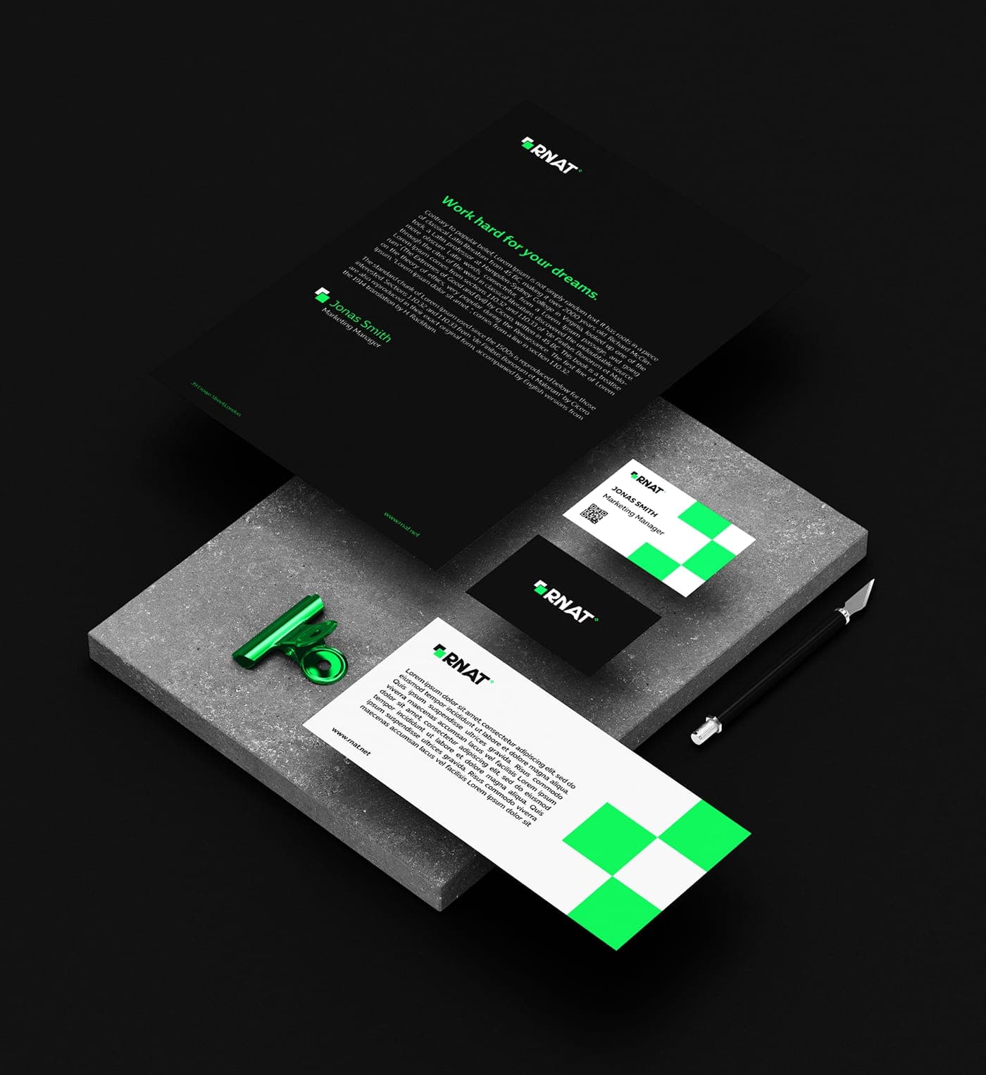 RNAT stationery mockup with letterhead, cards, pen, and brand materials