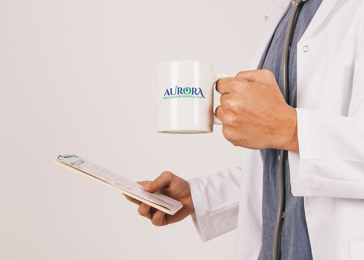 Aurora hospital logo applied to a mug held by a doctor